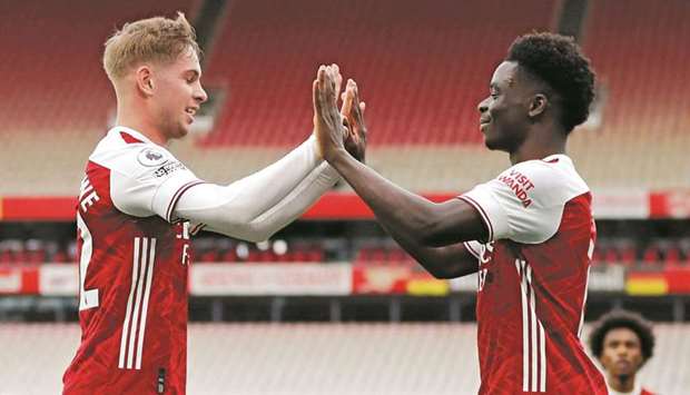 Arsenalu2019s Emile Smith Rowe (left) celebrates with Bukayo Saka after scoring against West Bromwich Albion in the Premier League on Sunday. (Reuters)