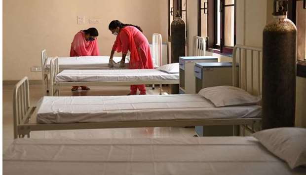 Health workers arrange beds for Covid-19 Coronavirus patients at a care centre in Amritsar, India