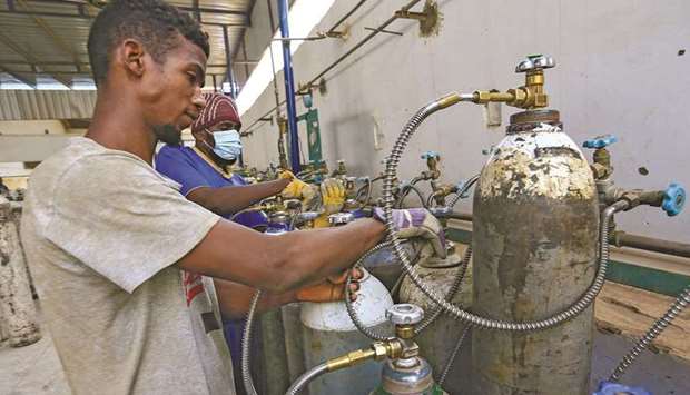 Workers prepare oxygen cylinders for coronavirus disease (Covid-19) patients inside the Sudanese Liquid Gas Company in Khartoum.