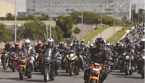 Bolsonaro gestures as he and his supporters ride motorcycles to celebrate the National Motheru2019s Day in Brasilia.