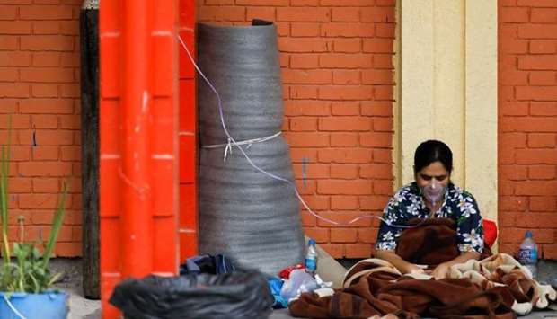 A patient receives oxygen as she waits outside the passage of a hospital due to a lack of free beds inside the hospital for coronavirus disease patients, as the second major coronavirus wave surges in Kathmandu, Nepal