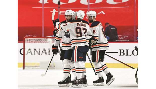Edmonton Oilers forward Connor McDavid (centre) celebrates with teammates after scoring the winning goal against the Montreal Canadiens during the overtime period at the Bell Centre in Montreal. (USA TODAY Sports)