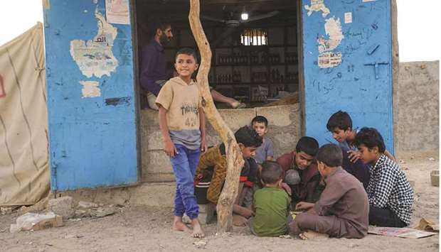 Boys play outside a shop at a makeshift camp for internally displaced people (IDPs) in the oil-producing Marib province in Yemen.