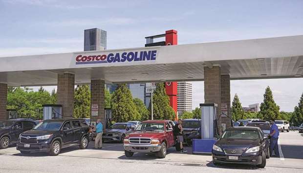 Consumers pump gas at a Costco gasoline station, in Atlanta, Georgia, yesterday.