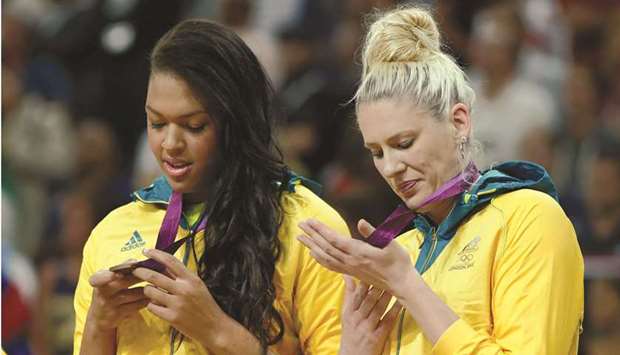 Australiau2019s Liz Cambage (L) and Lauren Jackson look at their bronze medals during the victory ceremony at the North Greenwich Arena during the London 2012 Olympic Games August 11, 2012. File photo