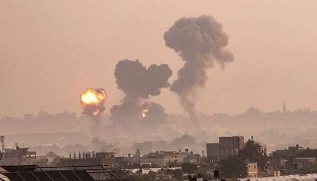 Fire billows from Israeli air strikes in Khan Yunis, in the southern Gaza Strip.
