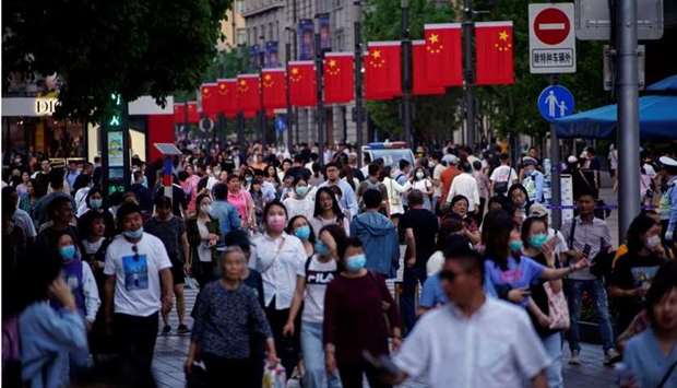 People walk along Nanjing Pedestrian Road, a main shopping area, in Shanghai, China. REUTERS