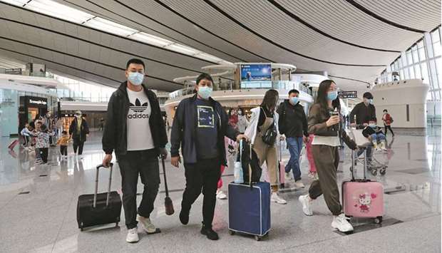 Travellers are seen at the Beijing Daxing International Airport on the first day of Labour Day holiday, in Beijing on May 1. Booming holiday travel and greater mobility has pushed motor fuel prices back to pre-pandemic levels in China.