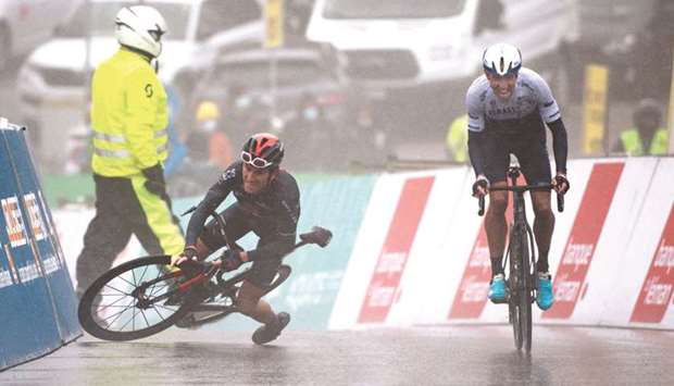 Britainu2019s Geraint Thomas (left) falls as Canadau2019s Michael Woods sprints past to victory in the fifth stage of the Tour de Romandie in Thyon, Switzerland, yesterday. (AFP)