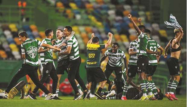Sportingu2019s players celebrate after winning the Portuguese League at the Jose Alvalade stadium in Lisbon on Tuesday. (AFP)