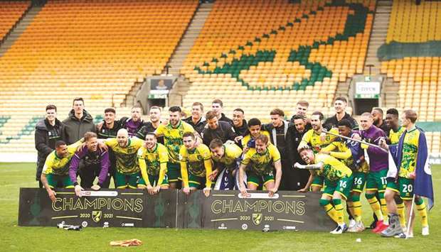 Norwich City players and support staff celebrate after winning the Championship yesterday. (Reuters)