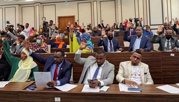 Somalia legislators vote by rising their hands to cancel a divisive two-year presidential term extension, inside the lower house of Parliament in Mogadishu, Somalia on Saturday. (Reuters)