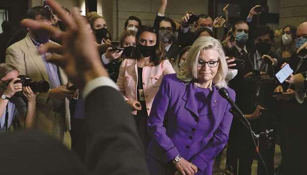 An aide motions for US Representative Liz Cheney to exit after taking a final question from reporters after her removal as chair of the House Republican Conference on Capitol Hill in Washington, US.