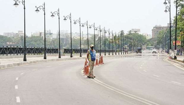 Police stand guard on a deserted street as the government imposed 10-day lockdown to curb the spread of Covid-19 pandemic in Hyderabad yesterday. Indiau2019s devastating Covid crisis is making investors question more than ever whether after years of debt accumulation and patchy progress on reforms, a country touted as a future economic superpower still deserves its u2018investment gradeu2019 status.