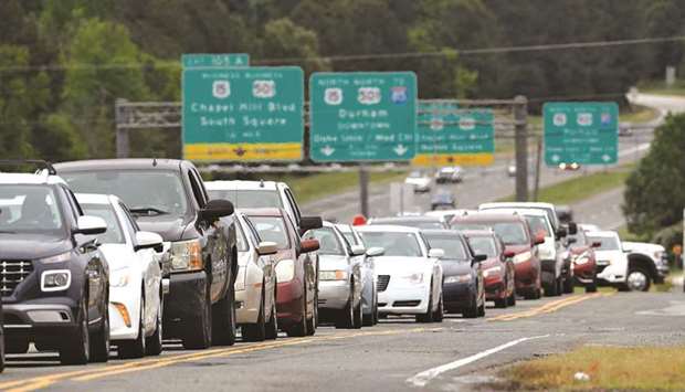 Scores of vehicles line up to enter a gasoline station as demand for fuel surges following the cyberattack that crippled the Colonial Pipeline, in Durham, North Carolina, US.
