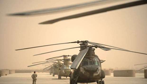 In this file photo taken on March 16, 2011, a US airman walks past a row of Chinook helicopters at Kandahar airbase in southern Afghanistan