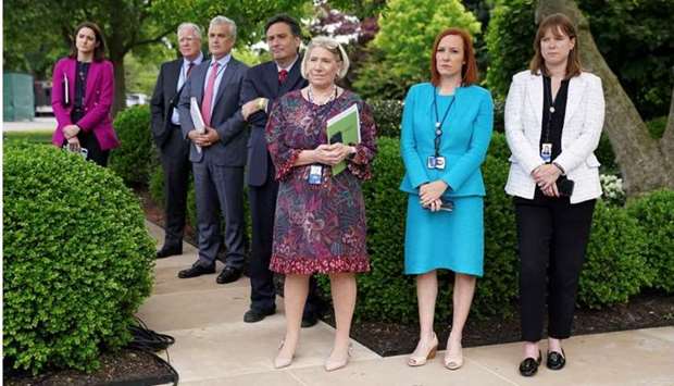 White House Chief of Staff Ron Klain, Senior Advisor to the President Anita Dunn, Press Secretary Jen Psaki, Communications Director Katherine Bedingfield and other staff members stand without protective face masks in the Rose Garden of the White House in Washington yesterday.