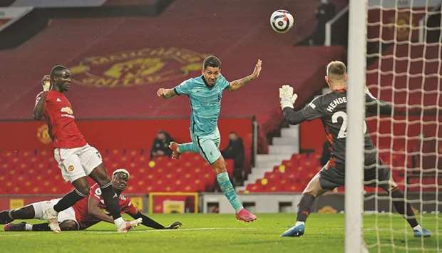 Liverpoolu2019s Roberto Firmino (centre) scores against Manchester United in the Premier League at Old Trafford, Manchester, on Thursday night. (Reuters)