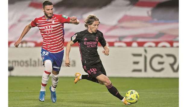 Granadau2019s Portuguese defender Domingos Duarte (left) vies for the ball with Real Madridu2019s Croatian midfielder Luka Modric in the La Liga on Thursday night. (AFP)