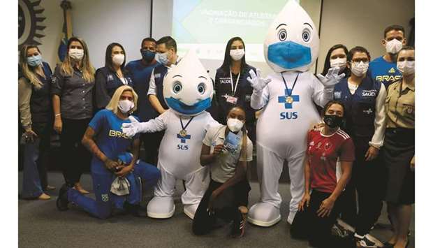 Brazilian athletes and staff travelling to Tokyo for the Olympics pose after receiving their Pfizer-BioNTech coronavirus disease (COVID-19) vaccine yesterday.