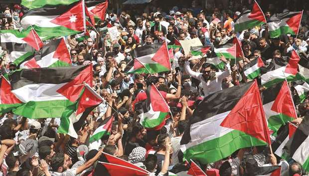 Jordanian demonstrators take part in a protest to express solidarity with the Palestinian people, in the capital Amman, yesterday.