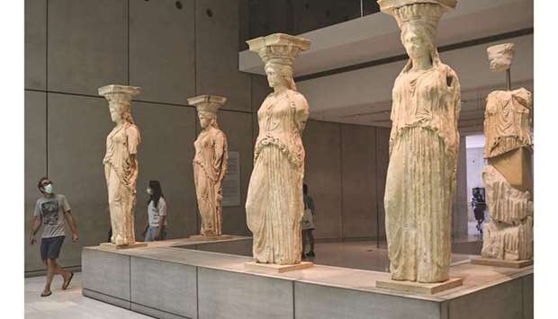 People visit the Athens Acropolis Museum during the first day of the opening, yesterday.