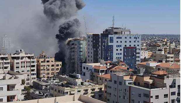Gaza tower housing Al Jazeera, AP is seen during a missile strike in Gaza city, May 15, 2021.