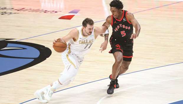 Dallas Mavericks guard Luka Doncic dribbles the ball as Toronto Raptors forward Stanley Johnson defends during the first quarter at American Airlines Center in Dallas. (USA TODAY Sports)