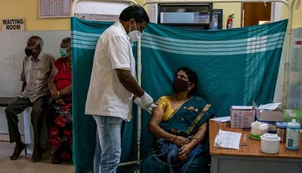 Minakshamma, 68, receives a dose of Covishield, a coronavirus disease vaccine manufactured by Serum Institute of India, at a vaccination centre in Bengaluru, May 13.
