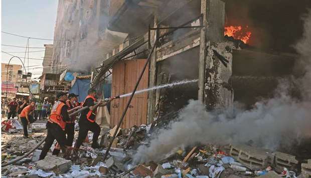 Palestinian firefighters battle a blaze following an Israeli strike on Rafah in the southern Gaza Strip, yesterday.