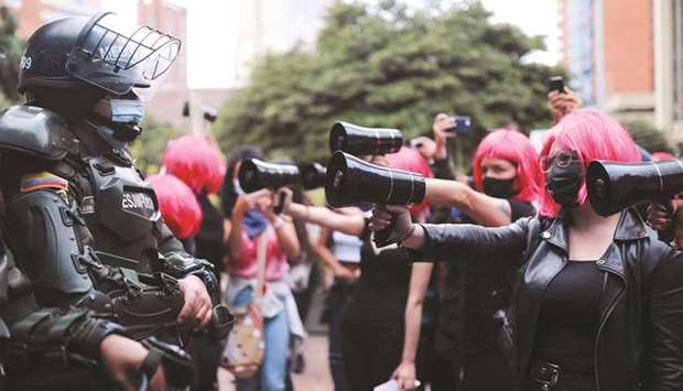 Women take part in a protest in Bogota yesterday against alleged abuses by the police.
