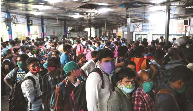 People queue up to buy tickets to return home at a bus station in Kolkata after the West Bengal government yesterday announced a 15-day lockdown to curb the spread of Covid-19.