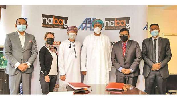 Nabay.com founder and chairman Nabeel Jawad Sultan, and MHD-ITICS chief investment officer Mohamed Abdallah al-Kharusi (3rd and 4th from left, respectively) joining members of both companiesu2019 executive and senior management after the signing ceremony.
