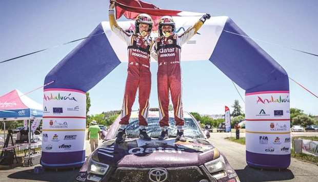 tQatar's Nasser Saleh al-Attiyah (right) and his French co-driver Matthieu Baumel celebrate their Andalucia Rally win in Villamartin, Spain, on Sunday.