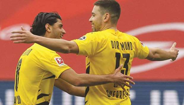 Dortmundu2019s Raphael Guerreiro (right) celebrates with teammate Mahmoud Dahoud during the Bundesliga match against Mainz 05 yesterday. (AFP)