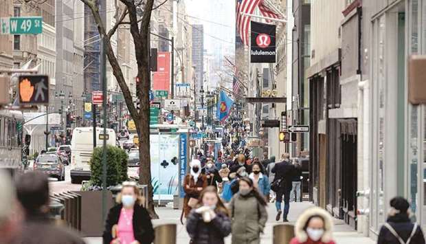 People walk on a busy 5th Avenue in midtown Manhattan. The prevailing scenario for the US recovery on Wall Street and in Washington has until recently focused on a boom fuelled by consumers roaring back to life with a vengeance in a vaccine-induced reopening of the economy.
