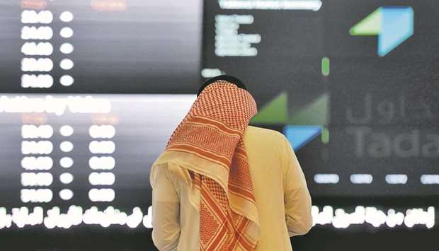 A Saudi investor monitors share prices at the Saudi Stock Exchange, or Tadawul (file). Nomu, the Saudi bourseu2019s secondary market, imposes lighter listing requirements to encourage smaller businesses and startups to raise equity.