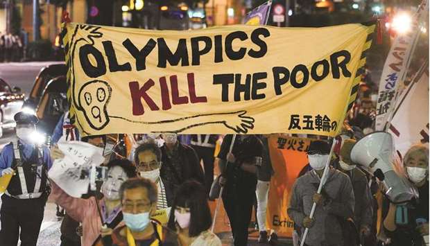 Anti-Olympics protesters carry banners during a march in Tokyo yesterday.