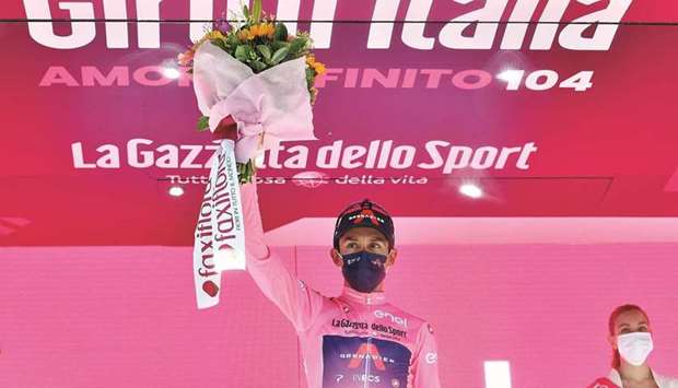 Ineos Grenadiers rider Egan Bernal Gomez of Colombia celebrates wearing overall leaderu2019s pink jersey on the podium. (Reuters)