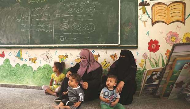 Palestinan families take shelter at a United Nations (UN) school in Rafah in the southern Gaza Strip yesterday, as Israeli air strikes continue.