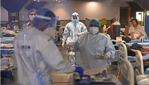 Health workers wearing PPE suits (Personal Protection Equipment) can be seen at a banquet hall turned into a Covid-19 coronavirus care center after surge in cases in New Delhi
