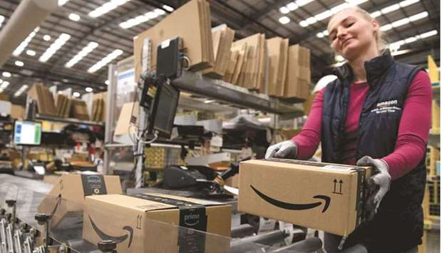 An Amazon worker packs items at the Amazon Fulfilment Centre in London. Amazonu2019s potential acquisition of  Metro-Goldwyn-Mayer would take one of the last major, independent movie studios off the market, capping a rush of streaming deals that are set to make 2021 a record year for media takeovers.