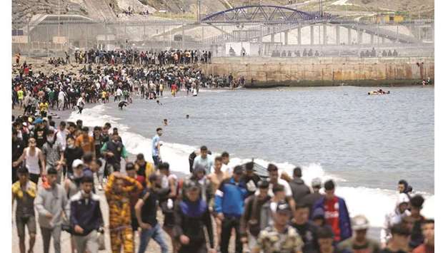 Migrants pictured between Morocco and the Spanish enclave of Ceuta yesterday in Fnideq. ( AFP)