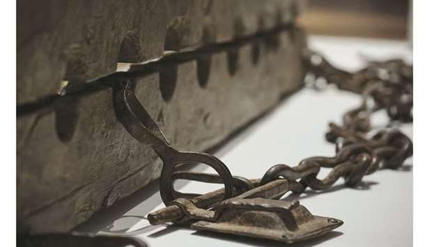 This picture taken on May 12, 2021 at the Rijksmuseum in Amsterdam during the exhibition u201cSlaveryu201d shows multiple foot stocks for constraining enslaved people. (AFP)