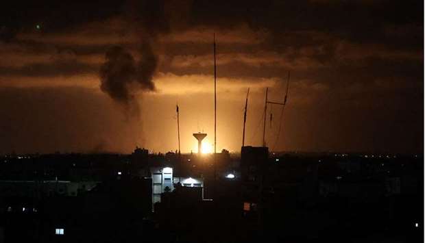A ball of fire illuminates the horizon during an Israeli airstrike in Rafah in the southern Gaza Strip