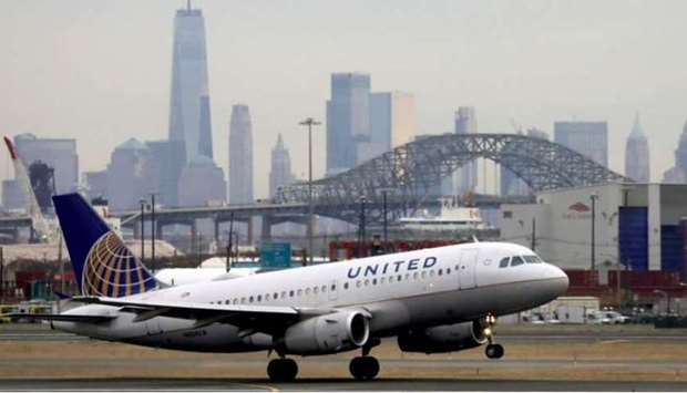 A United Airlines passenger jet takes off with New York City as a backdrop, at Newark Liberty International Airport, New Jersey, U.S.
