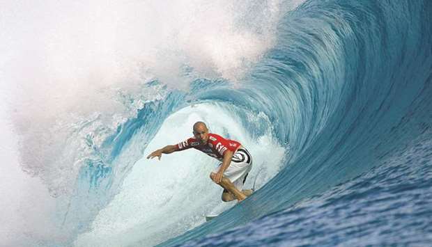File photo of Surfer Kelly Slater of the US riding a wave during the third round of the Billabong Pro tournament on the legendary reef break in Teahupoo, Tahiti, earlier this month.
