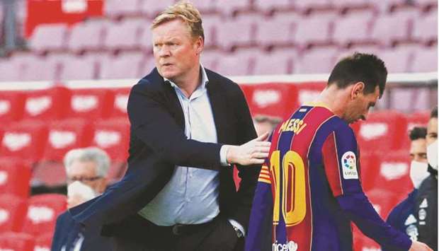 Barcelona coach Ronald Koeman greets Lionel Messi after the La Liga match against Celta Vigo in Barcelona, Spain, on Sunday. (Reuters)