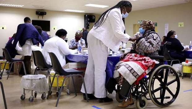 A woman receives a dose of a coronavirus vaccine as South Africa rolls out Covid-19 vaccines to the elderly