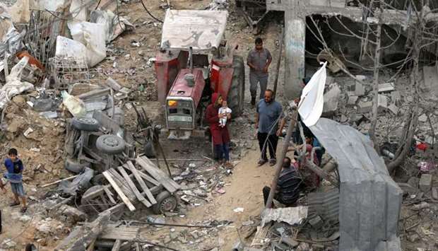 Palestinians return to their houses which were destroyed by Israeli strikes in the recent cross-border violence between Palestine and Israel, following Israel-Hamas truce, in Gaza
